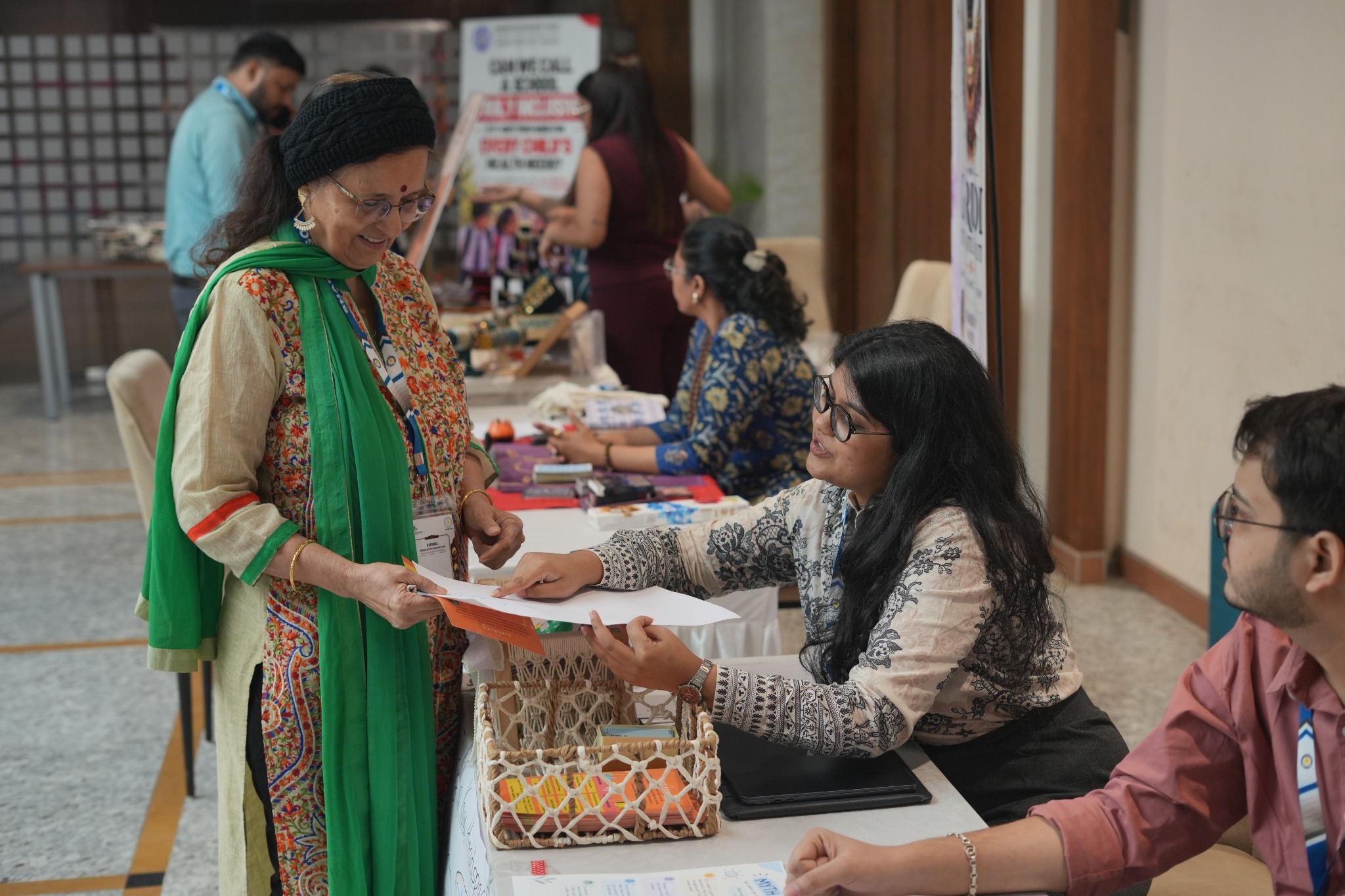 A delegate interacts with the team at an exhibition stall during NSHC 2026.