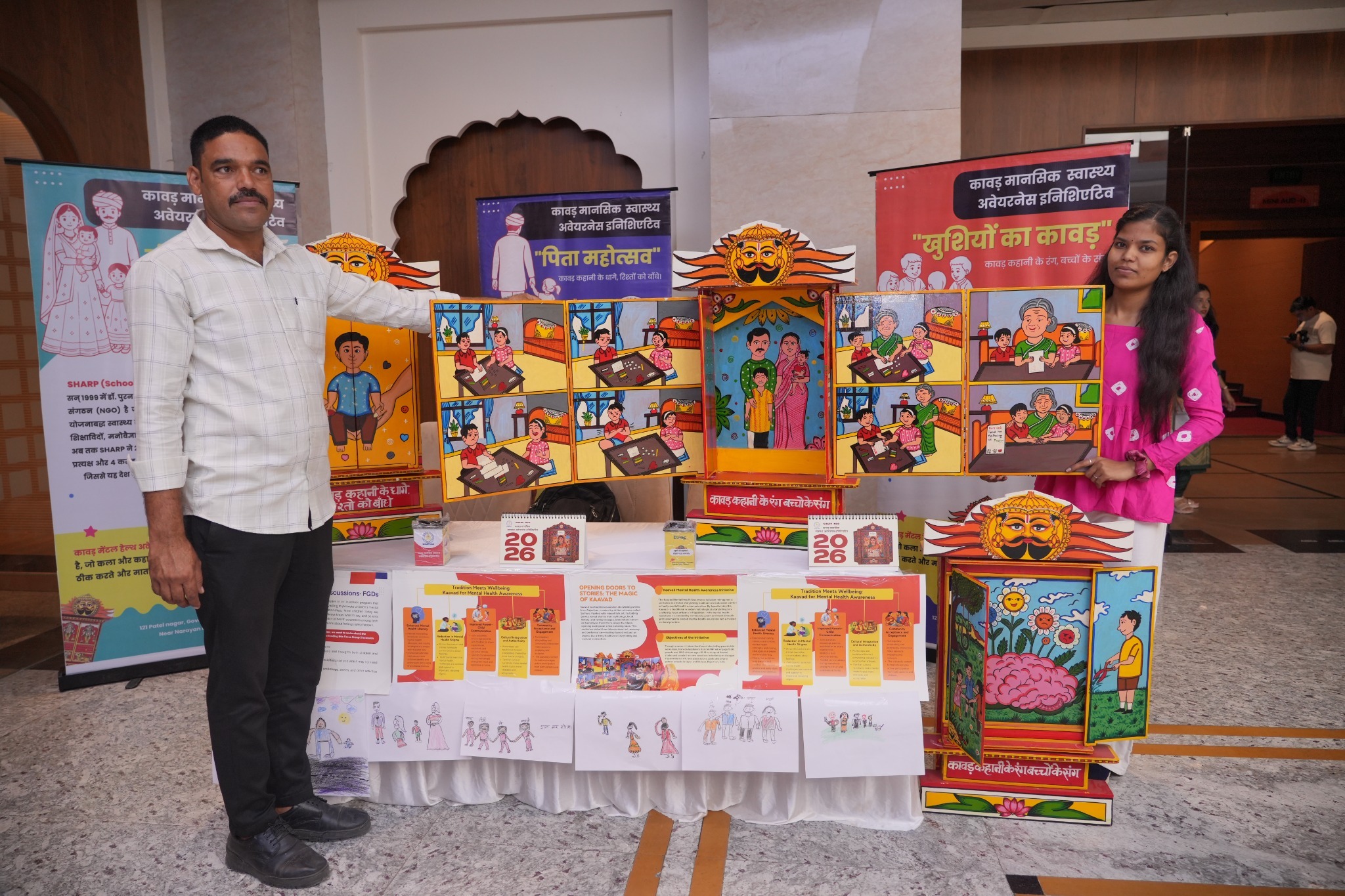The open Kaavad at the mental health exhibition illustrates stories of family relationships and emotional wellbeing.